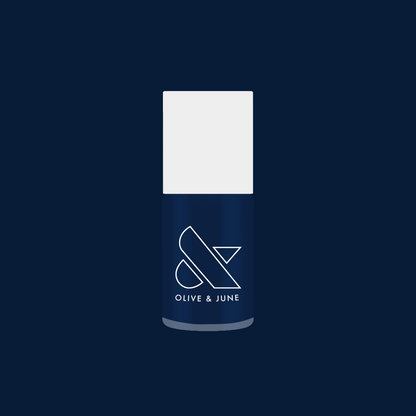 Olive and June bottle of Ack, A Shark! nail polish in deep navy blue for a long-lasting gel mani finish