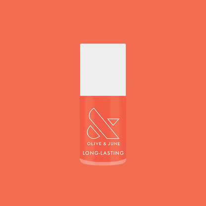 Olive and June Ride into the Sunset long-lasting gel polish bottle on matching coral background