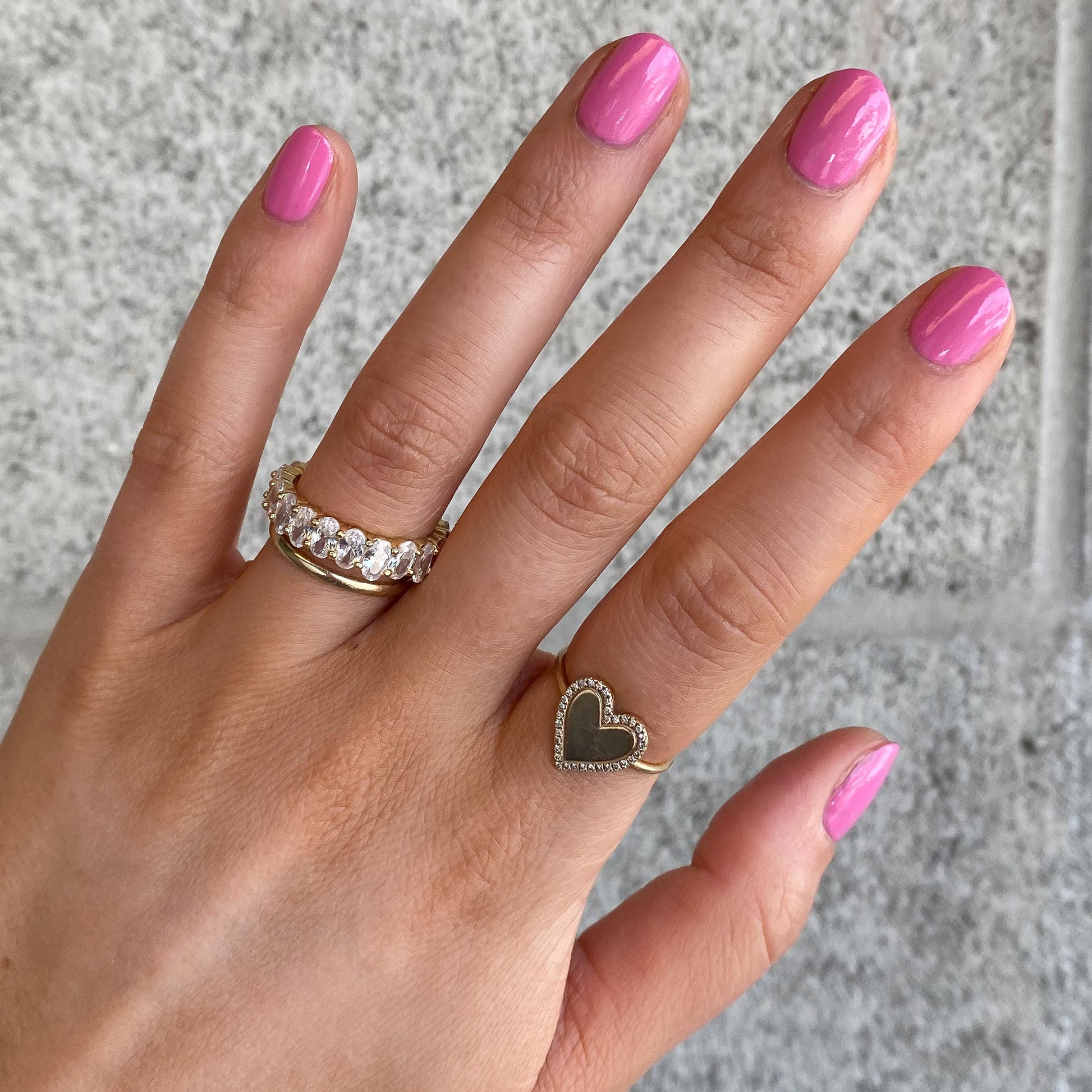 Hand with nails painted in Grateful & Kind pink gel polish showing a shiny, long-lasting manicure by Olive and June