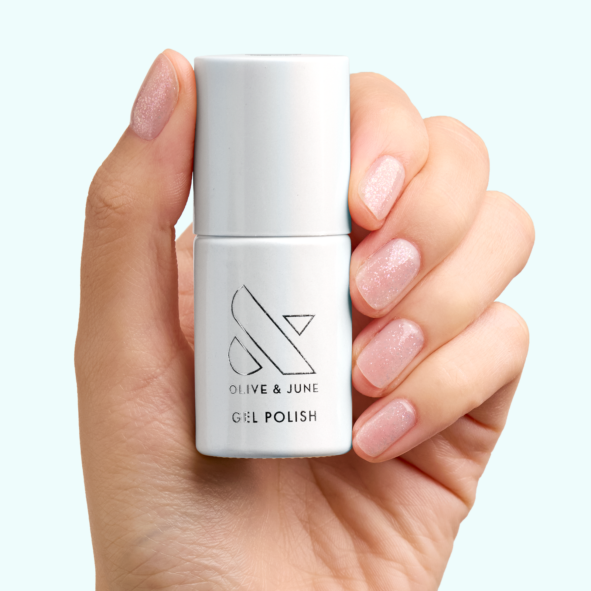 Hand holding DIAMONDS ARE A MANI’S BEST FRIEND Gel with nails polished in sparkly sheer iridescent gel for manicures