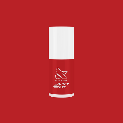 Lollipop quick dry polish bottle in classic cherry red by Olive and June on red background