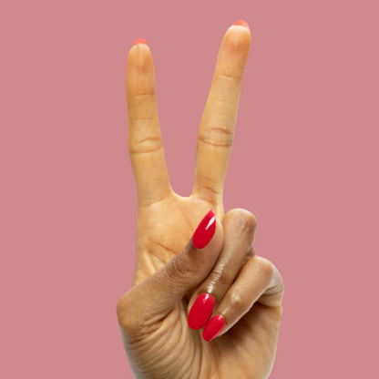 Secret Recipe - Gel smooth blue-toned red gel polish on nails shown in a glossy at-home manicure against pink background